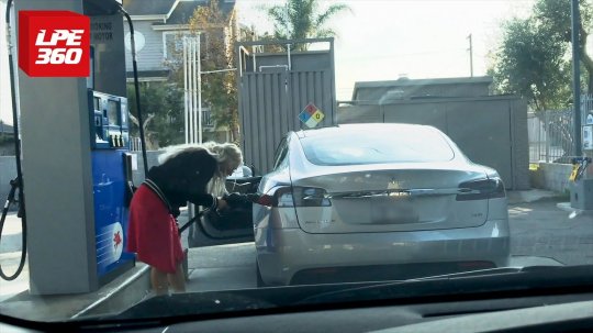 Woman tries putting gas in a Tesla